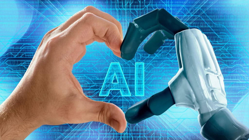 Mão humana e braço robótico formando um coração — conceito de amor, inteligência artificial e bate-papo virtual. / Crédito: TSViPhoto (Shutterstock)