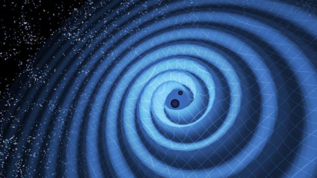 Ilustração representa a fusão de dois buracos negros detectados pelo LIGO em 2015. Com massas de 14 e 8 vezes a do Sol, eles se uniram formando um único buraco negro de 21 massas solares. O evento gerou ondas gravitacionais, embora essas ondulações sejam invisíveis a olho nu